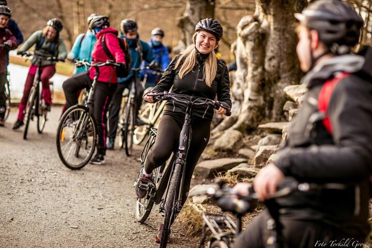 a group of people riding bikes on a trail