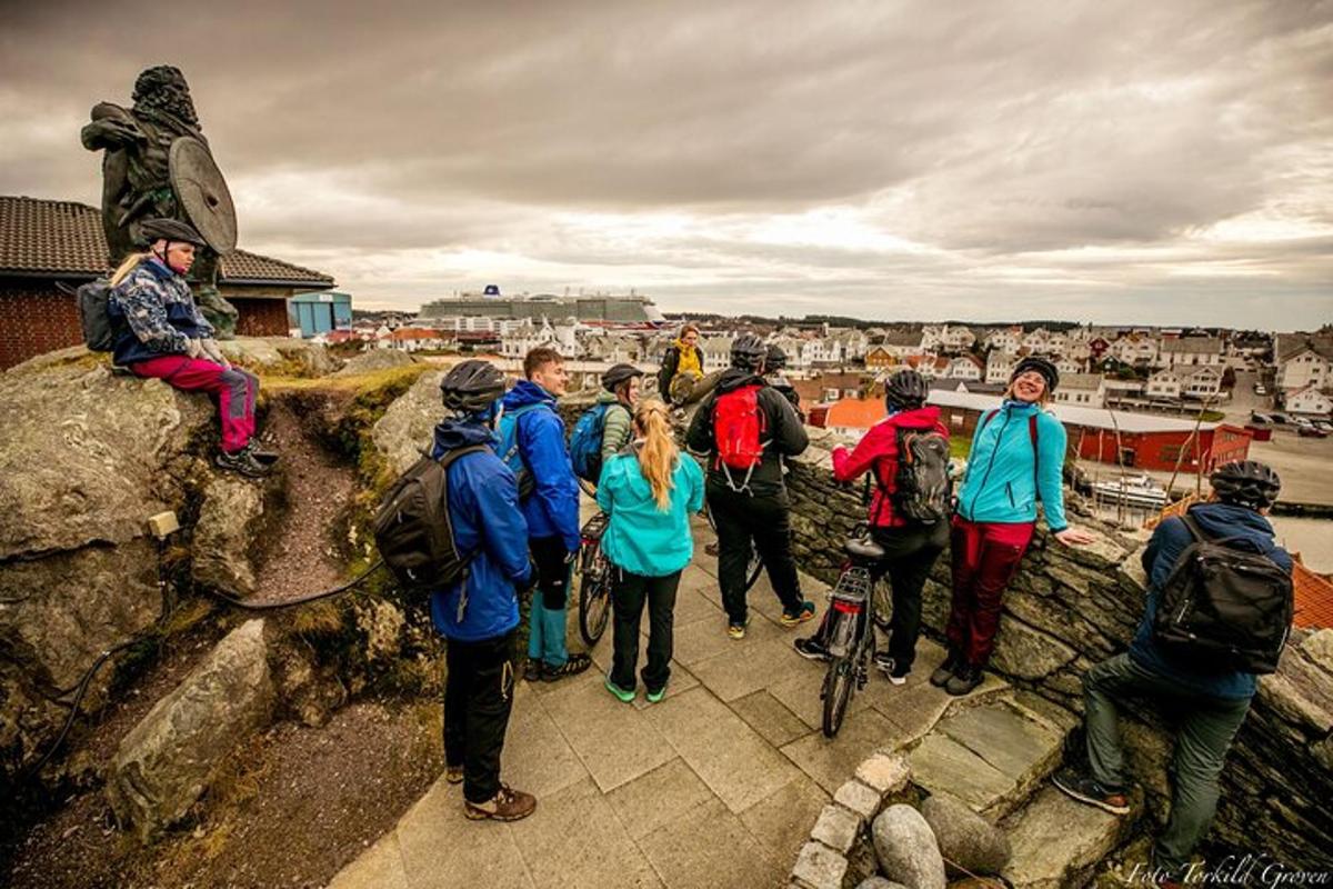 a group of people standing on top of a rock wall