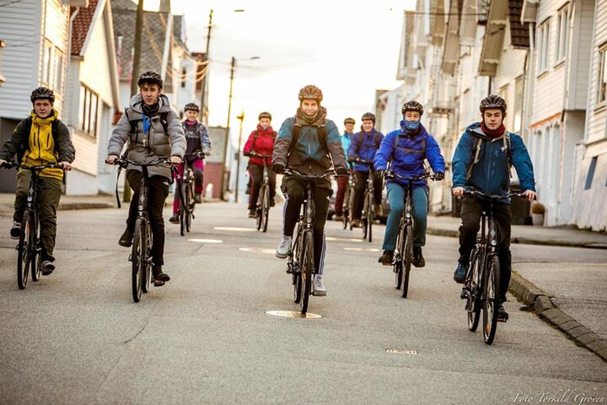 a group of people riding bikes down a street