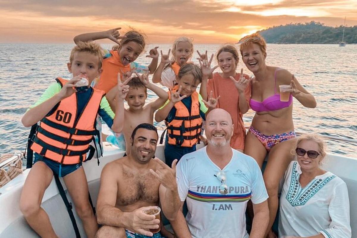 a group of people posing for a picture on a boat