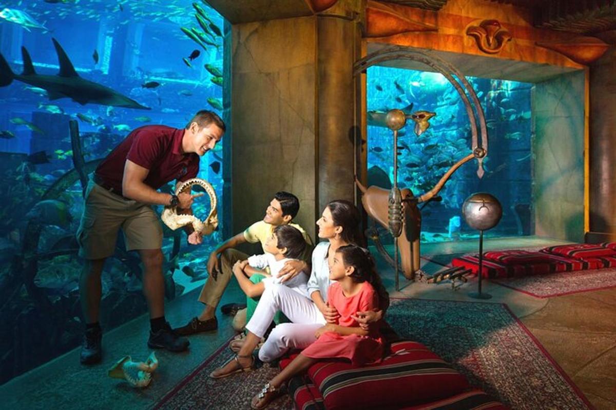 a man with a family in front of an aquarium