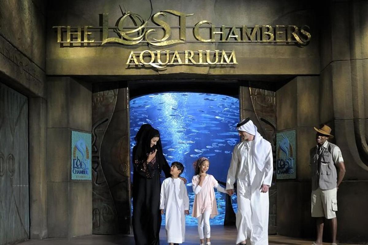 a group of people standing in front of an aquarium