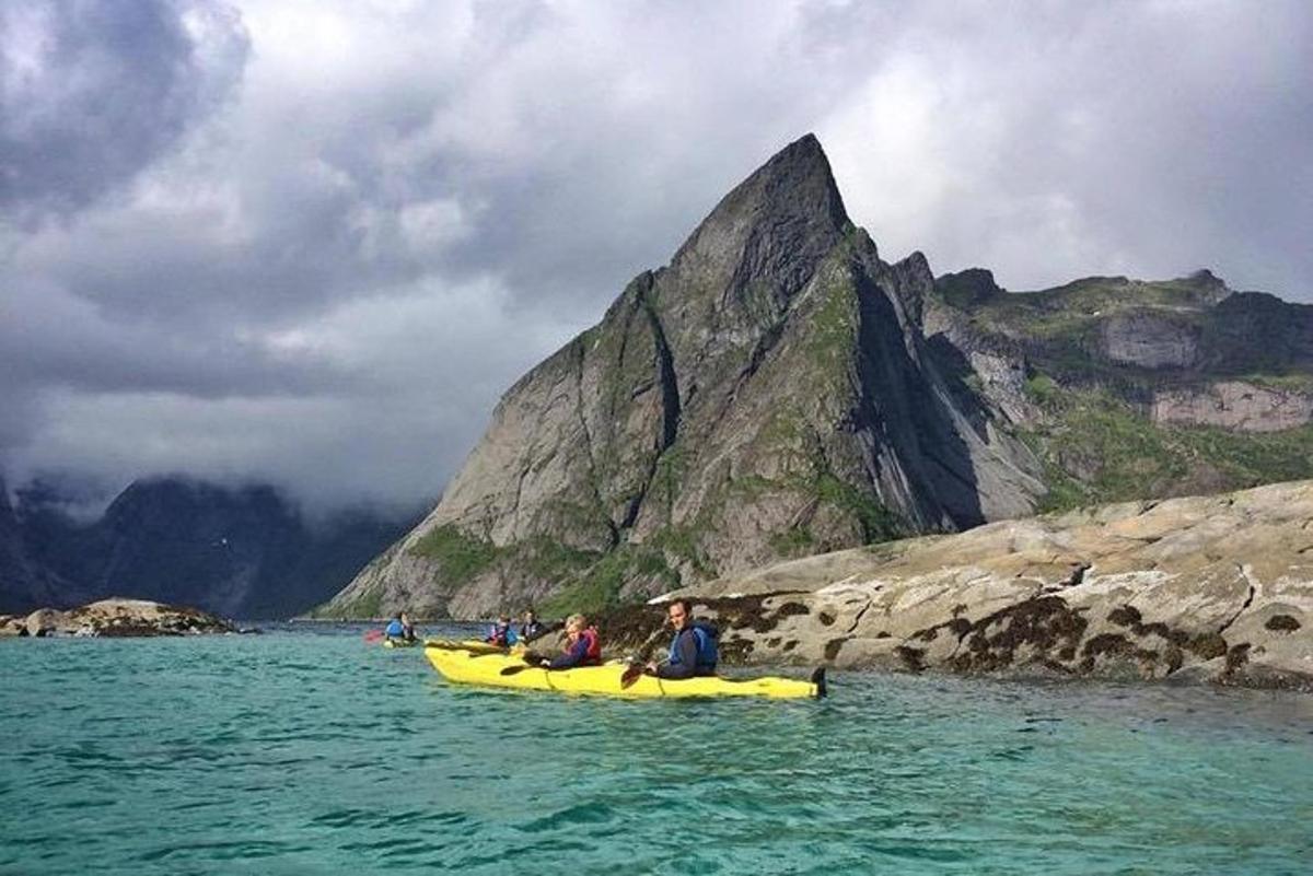a group of people in a yellow raft in the water