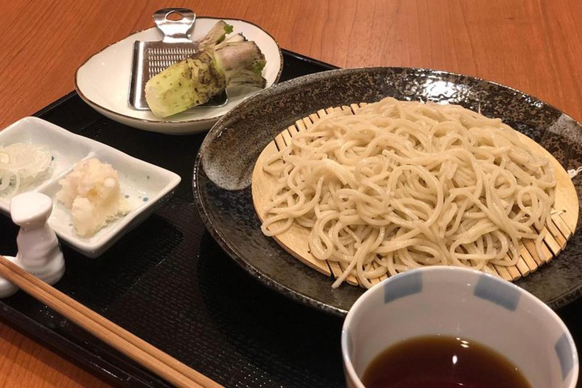 a tray with a plate of noodles and a bowl of soup