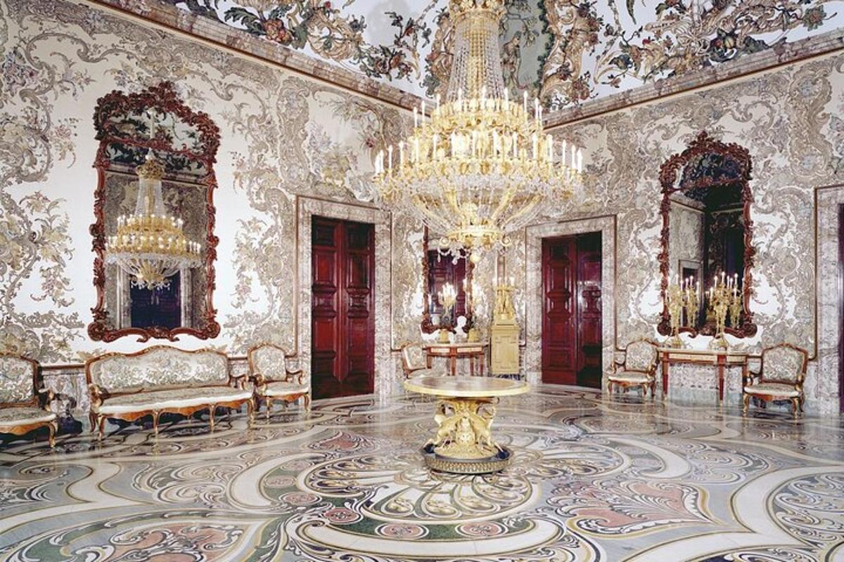 a large room with a chandelier and a table in it