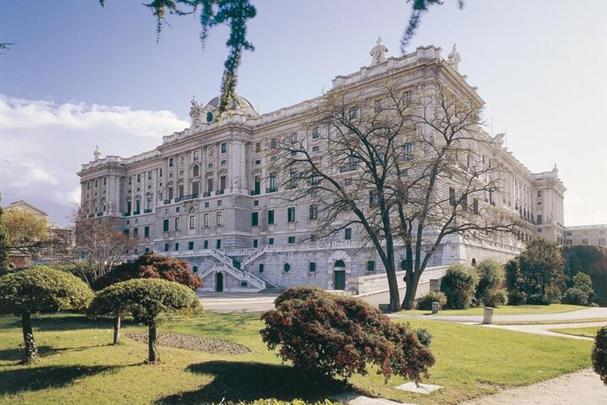 a large white building with trees in front of it