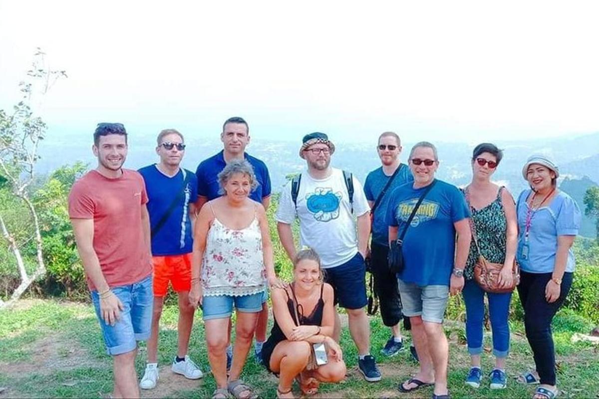 a group of people posing for a picture on a mountain