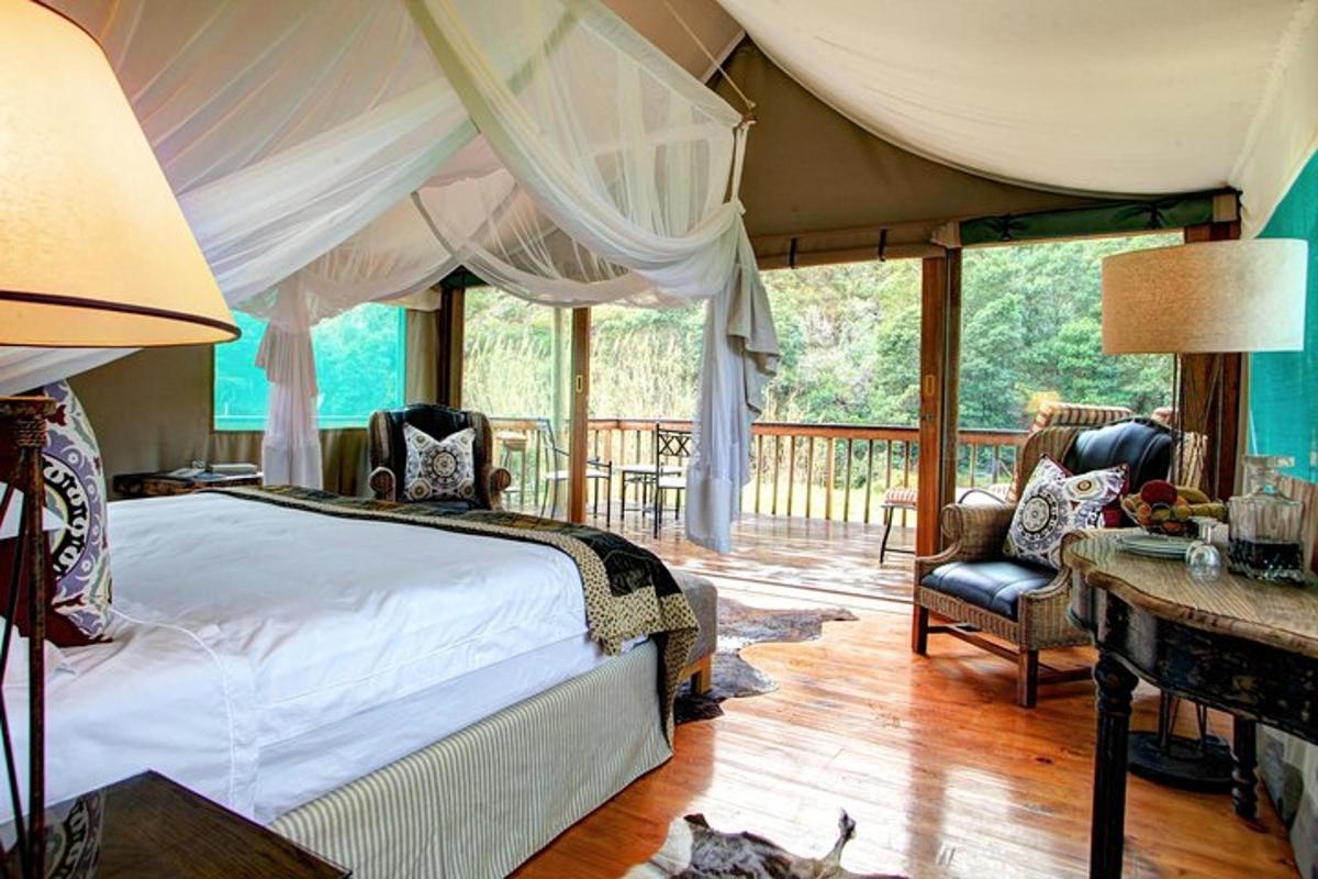 a bedroom with a bed and a table and chairs
