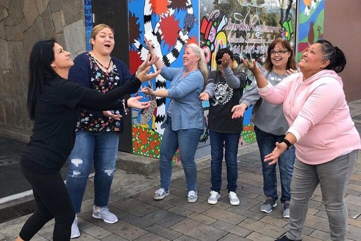 a group of women standing in the street with their hands up
