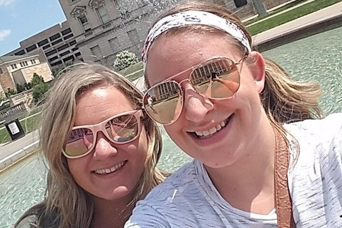 two young women wearing sunglasses posing for a picture