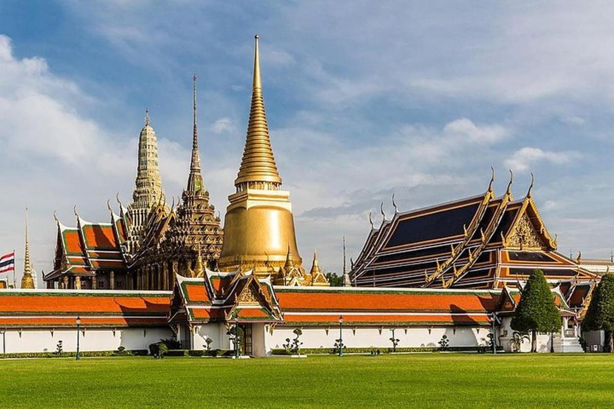 a building with gold turrets and a building with green grass