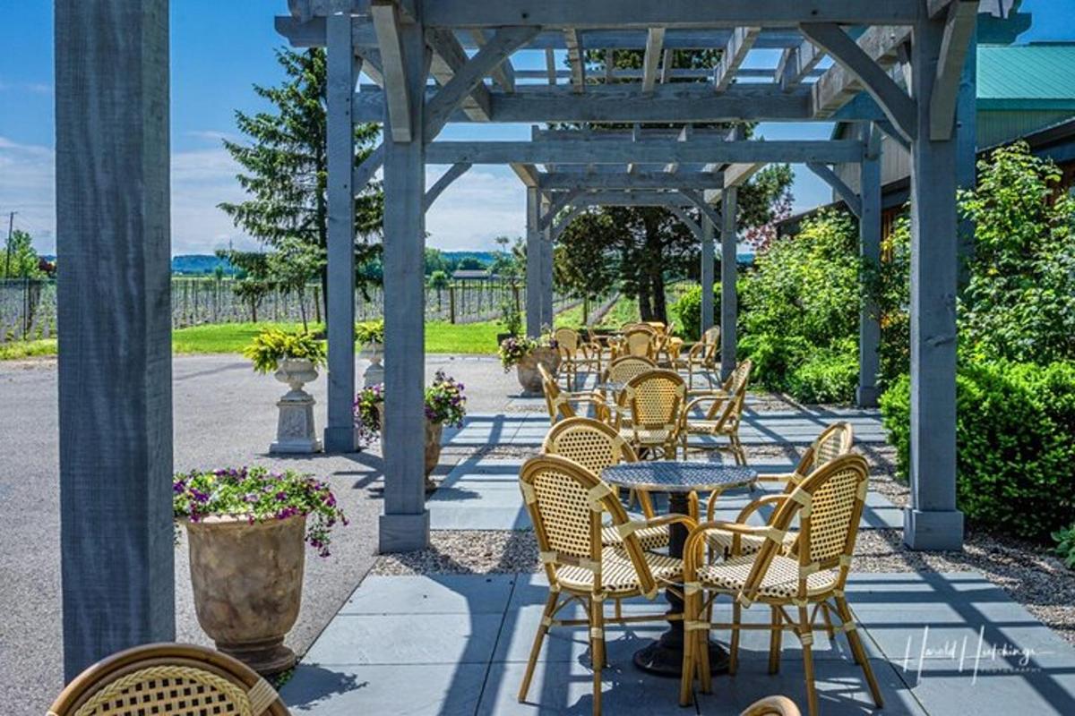 a group of chairs and tables under a pergola