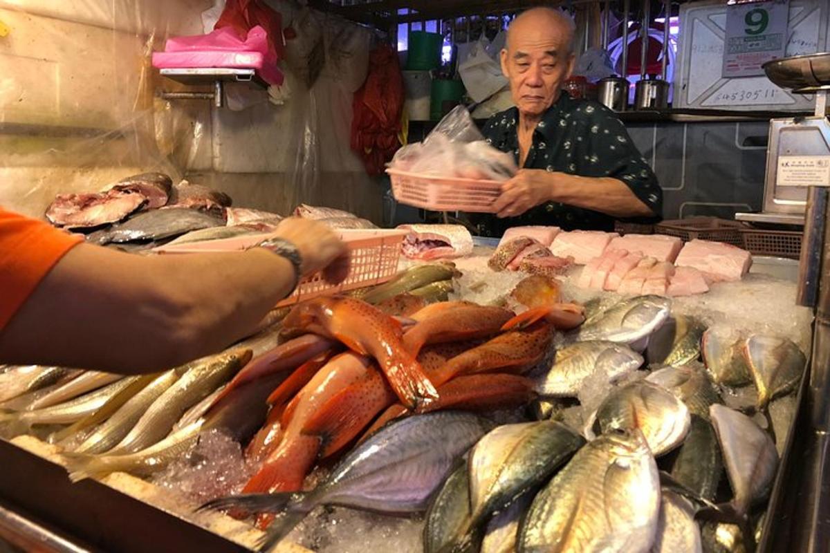 a man selling fish at a fish market