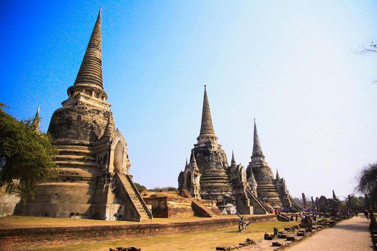 a group of pagodas sitting in a field with a road
