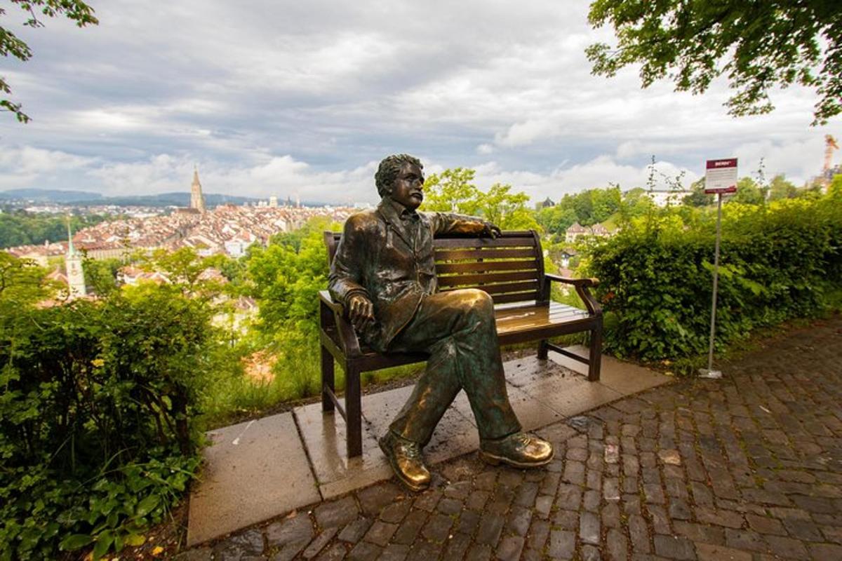 a statue of a man sitting on a bench