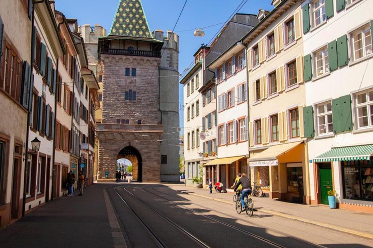 a person riding a bike down a street with a tower