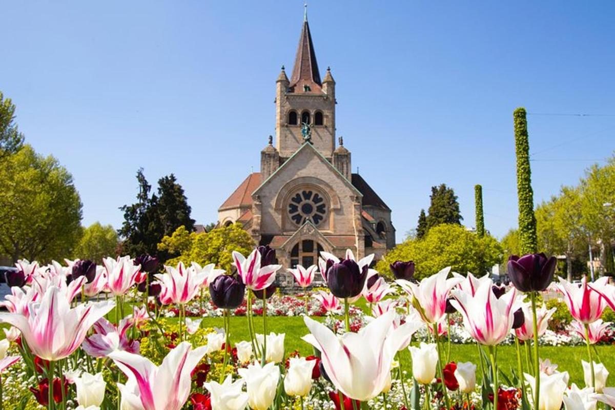 a field of flowers in front of a church