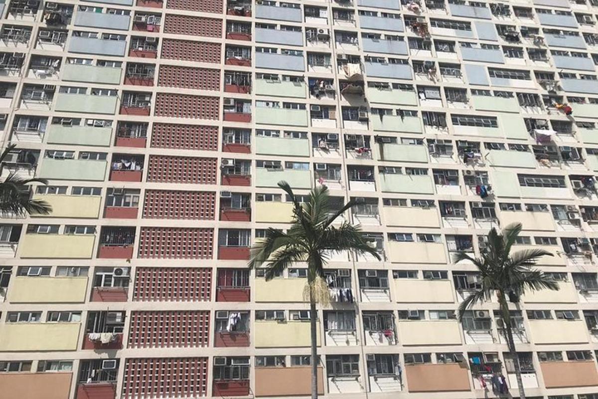 a tall building with palm trees in front of it
