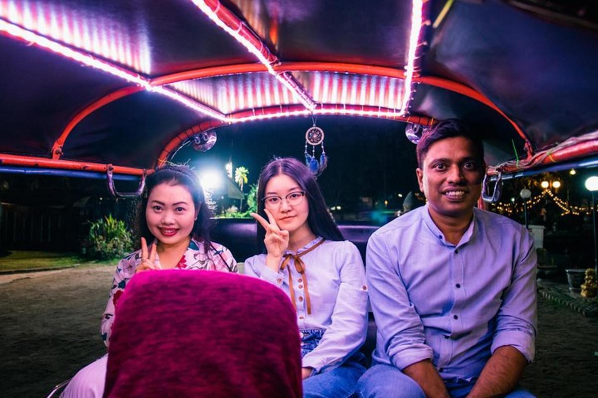 a group of three people sitting in the back of a truck