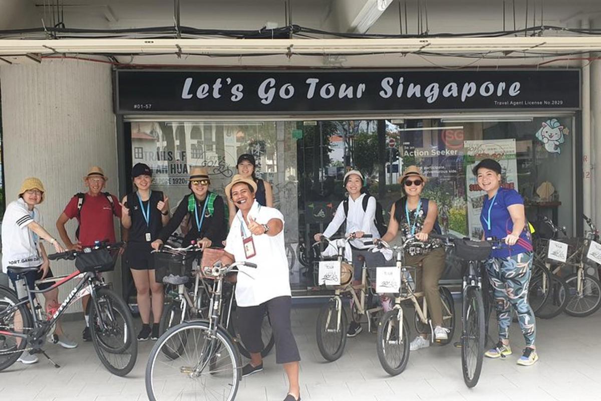 a group of people standing in front of a store with their bikes