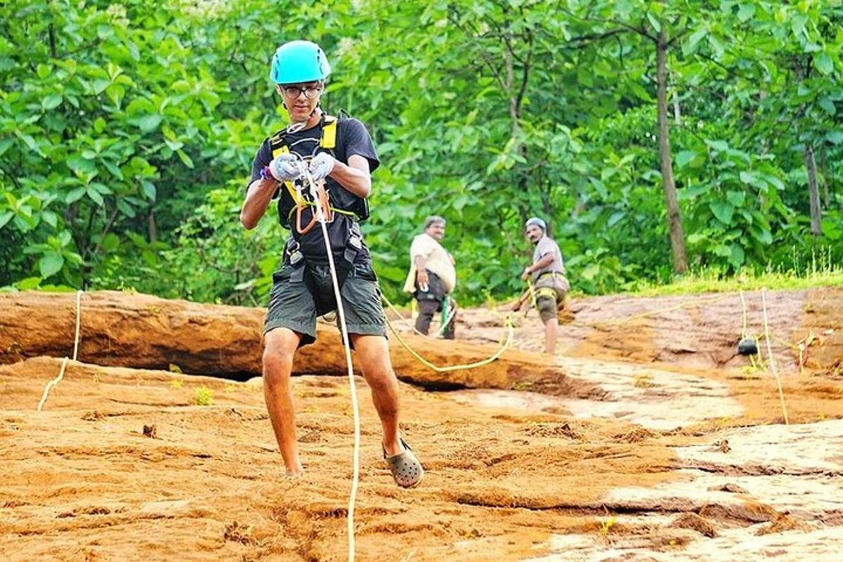 a man is walking in the mud with a rope
