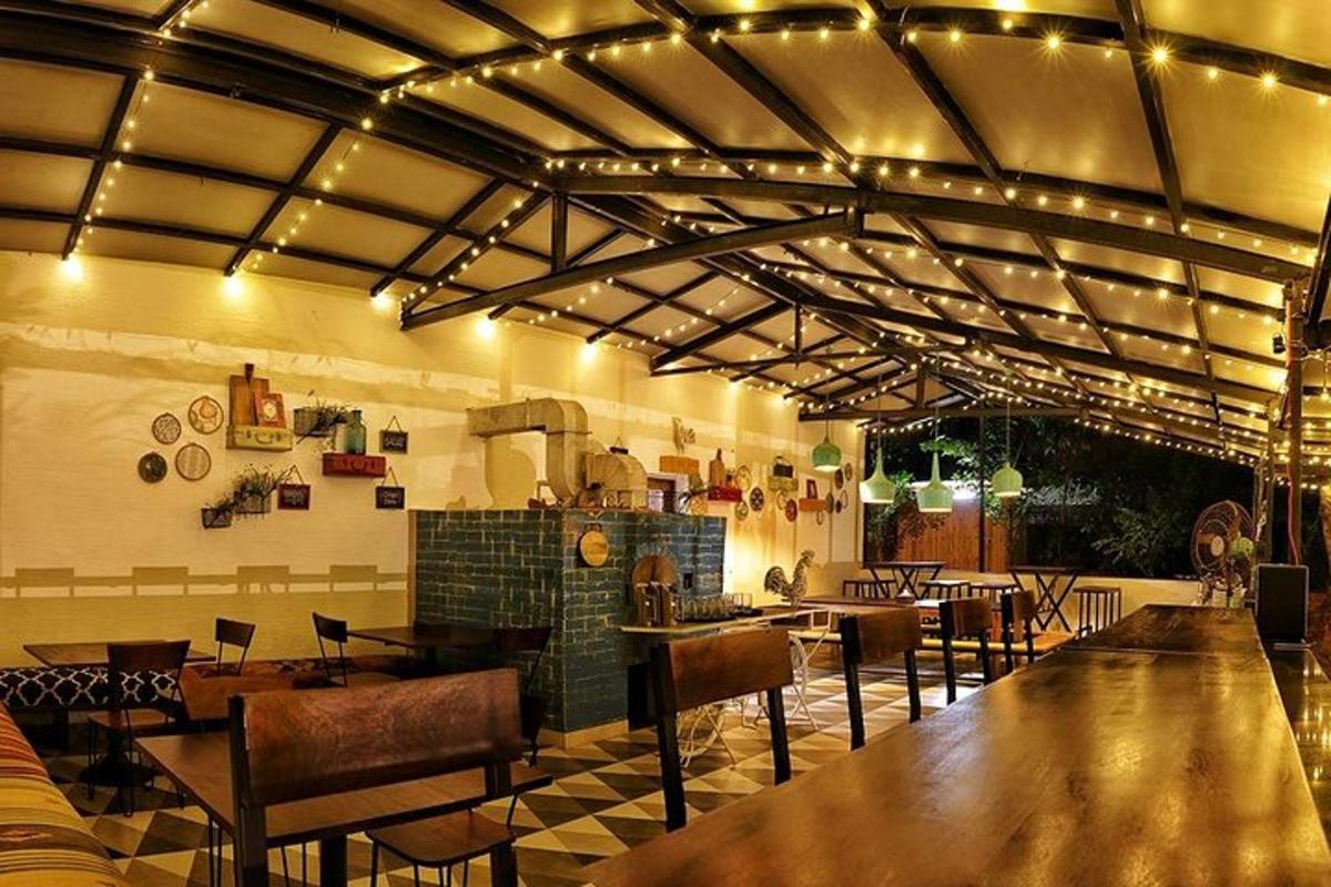 a restaurant with tables and chairs and lights on the ceiling