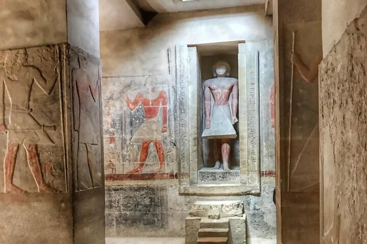 a room with a painting of a woman and a statue
