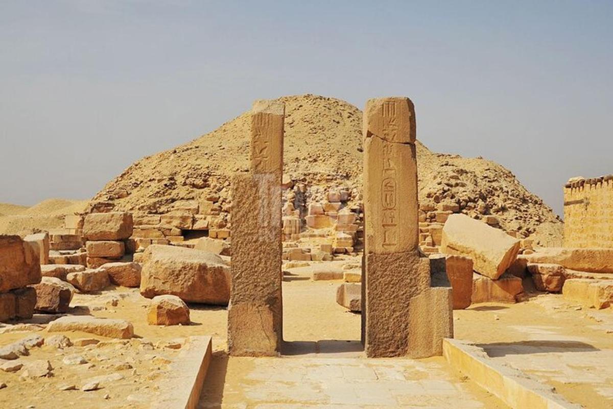 a group of columns in front of a pyramid