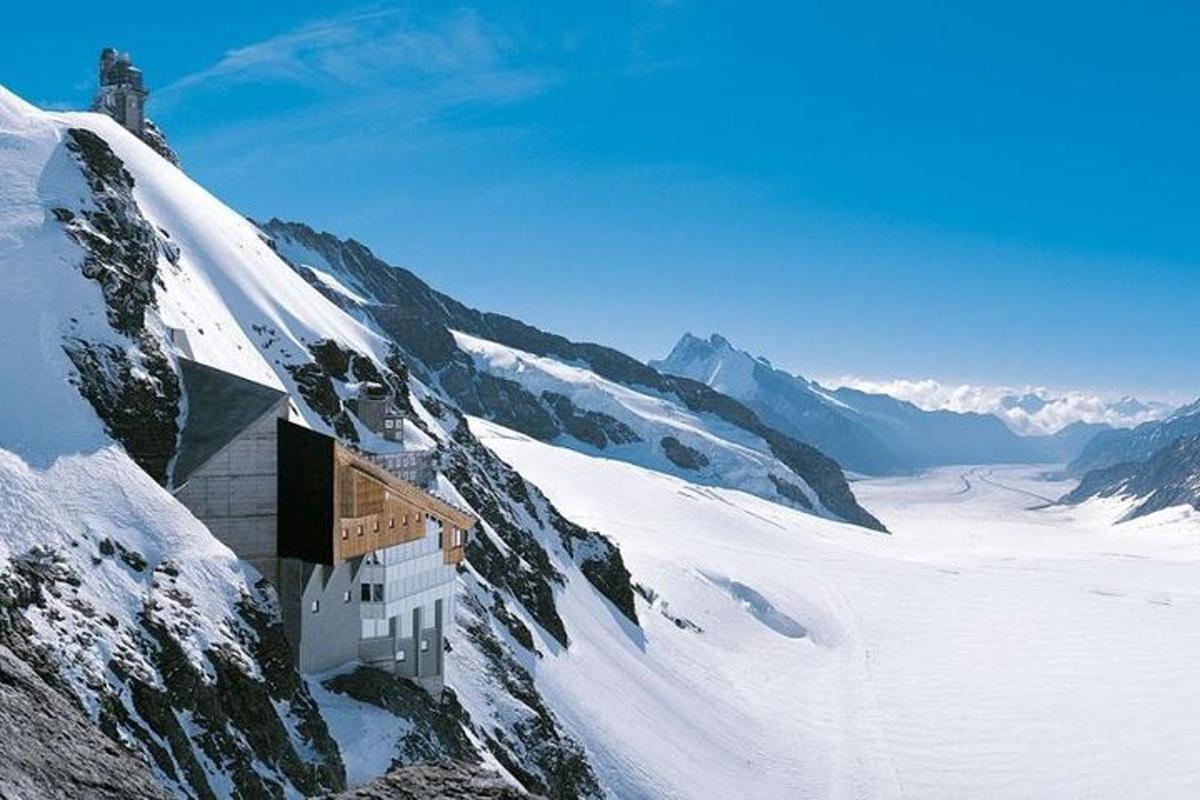 a building on the side of a snow covered mountain