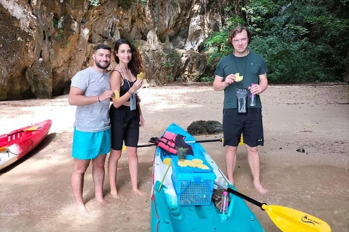 a group of three people standing on a beach