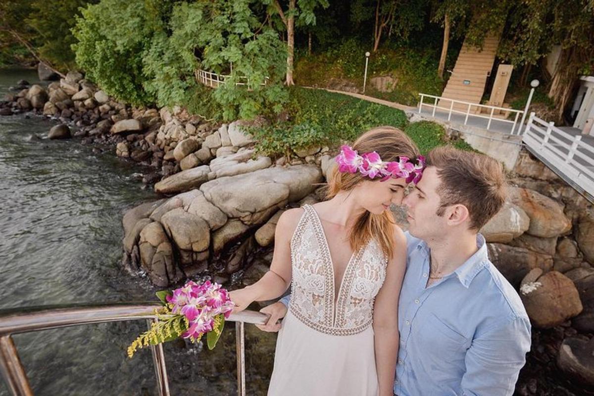 a man and a woman kissing next to a river