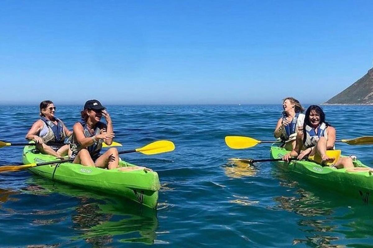 a group of people sitting in kayaks in the water
