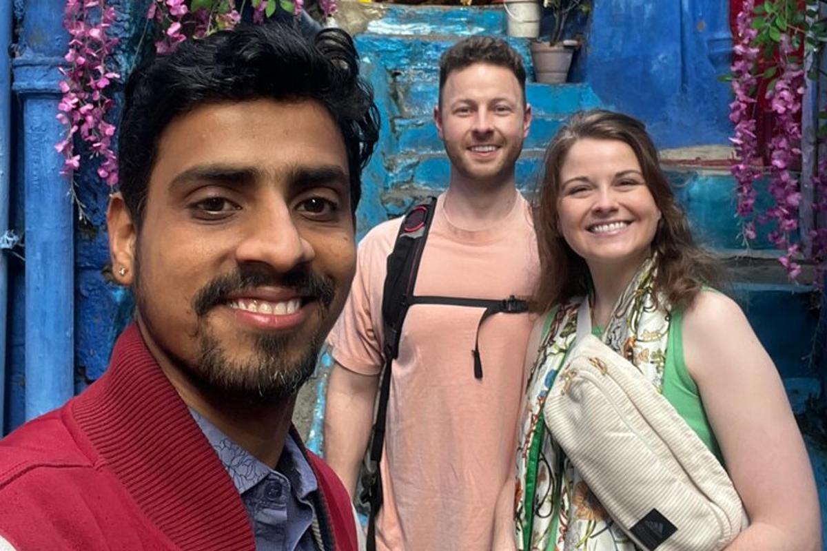 two men and a woman posing for a picture