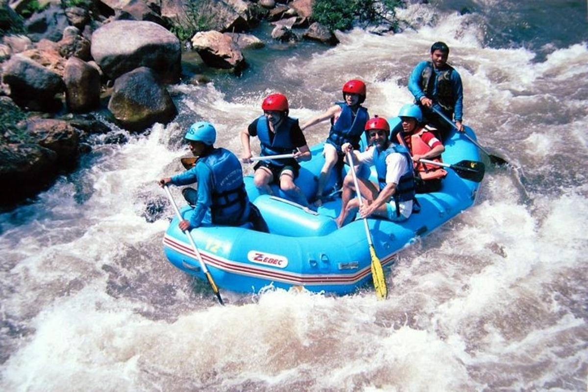 a group of people in a raft on a river