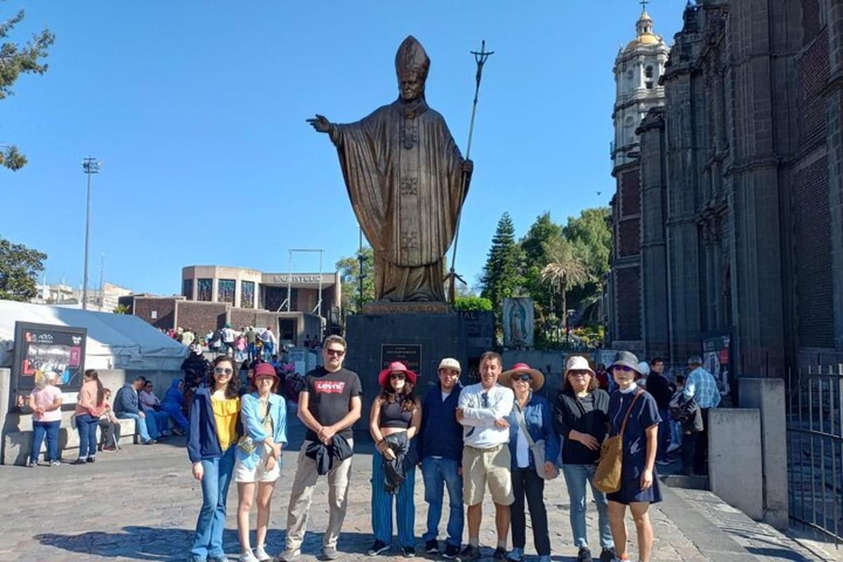 a group of people standing in front of a statue