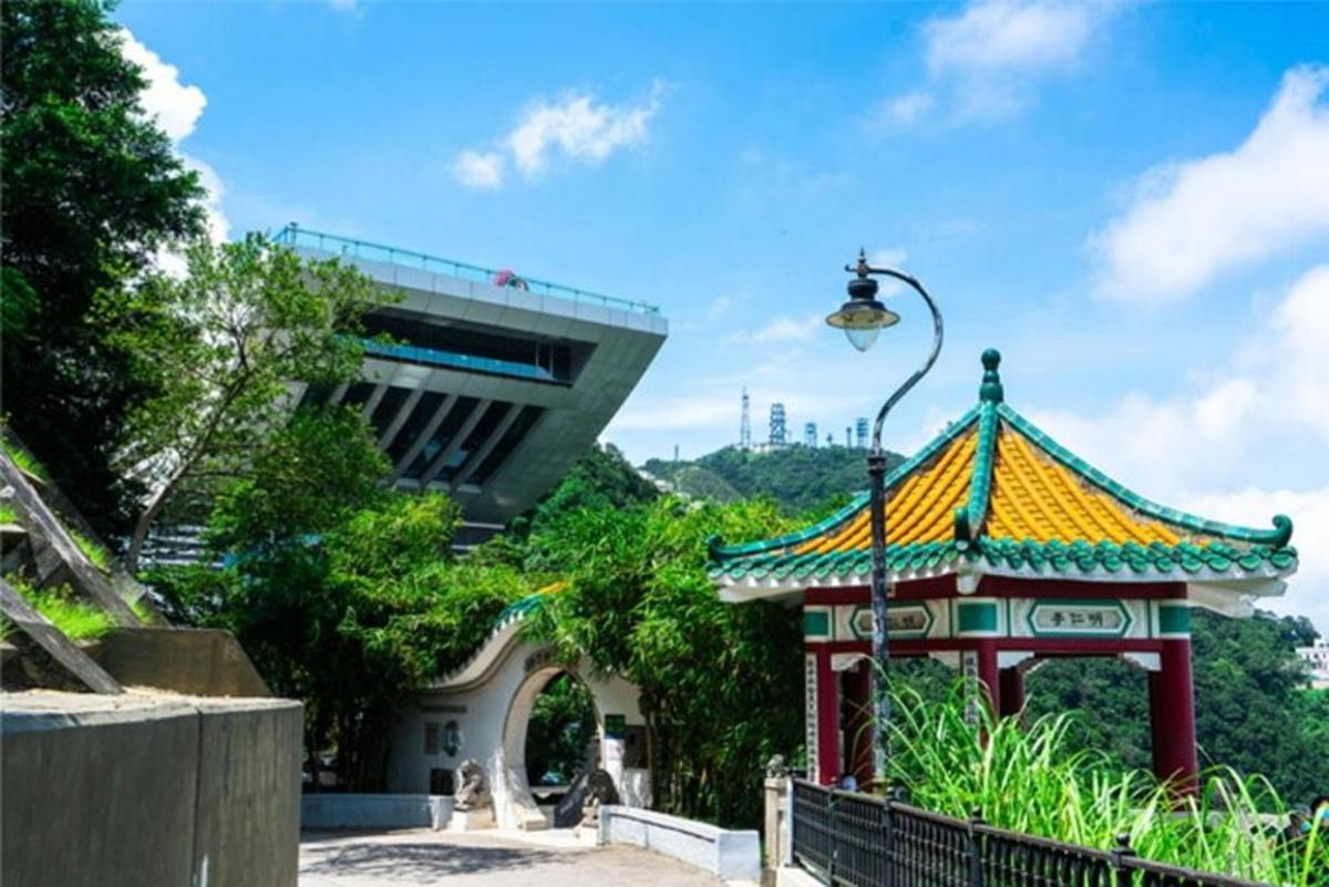 a pagoda in front of a building with a street light