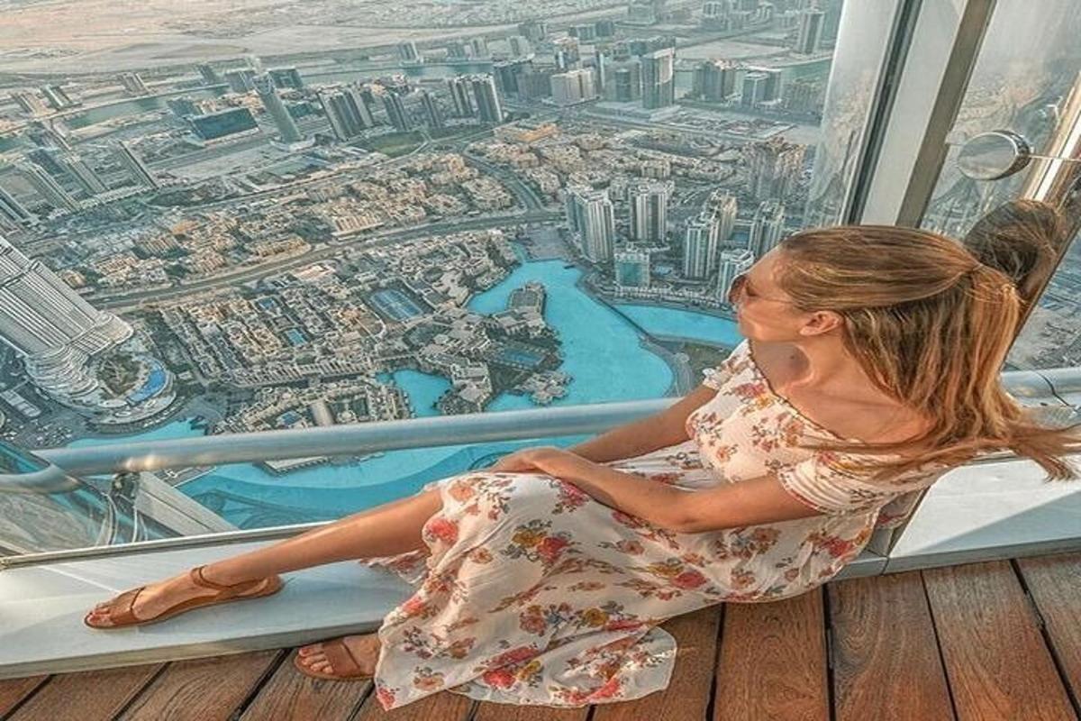 a woman sitting on the floor of a skyscraper