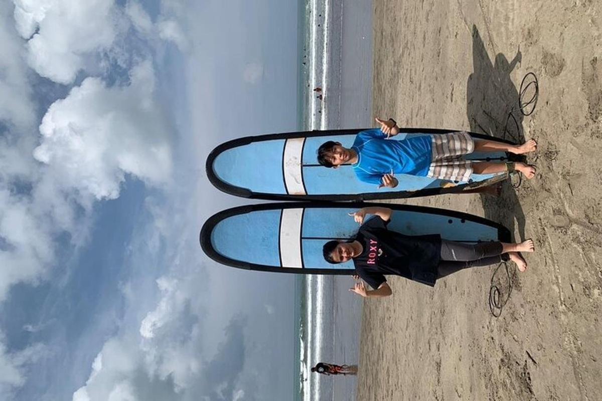 two people are standing with surfboards on a beach