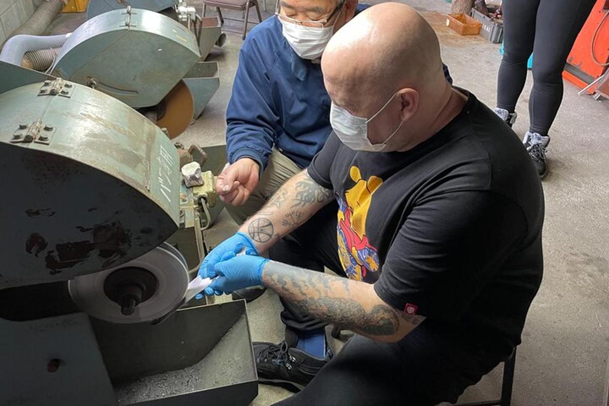 a man with a tattoo on his arm using a machine