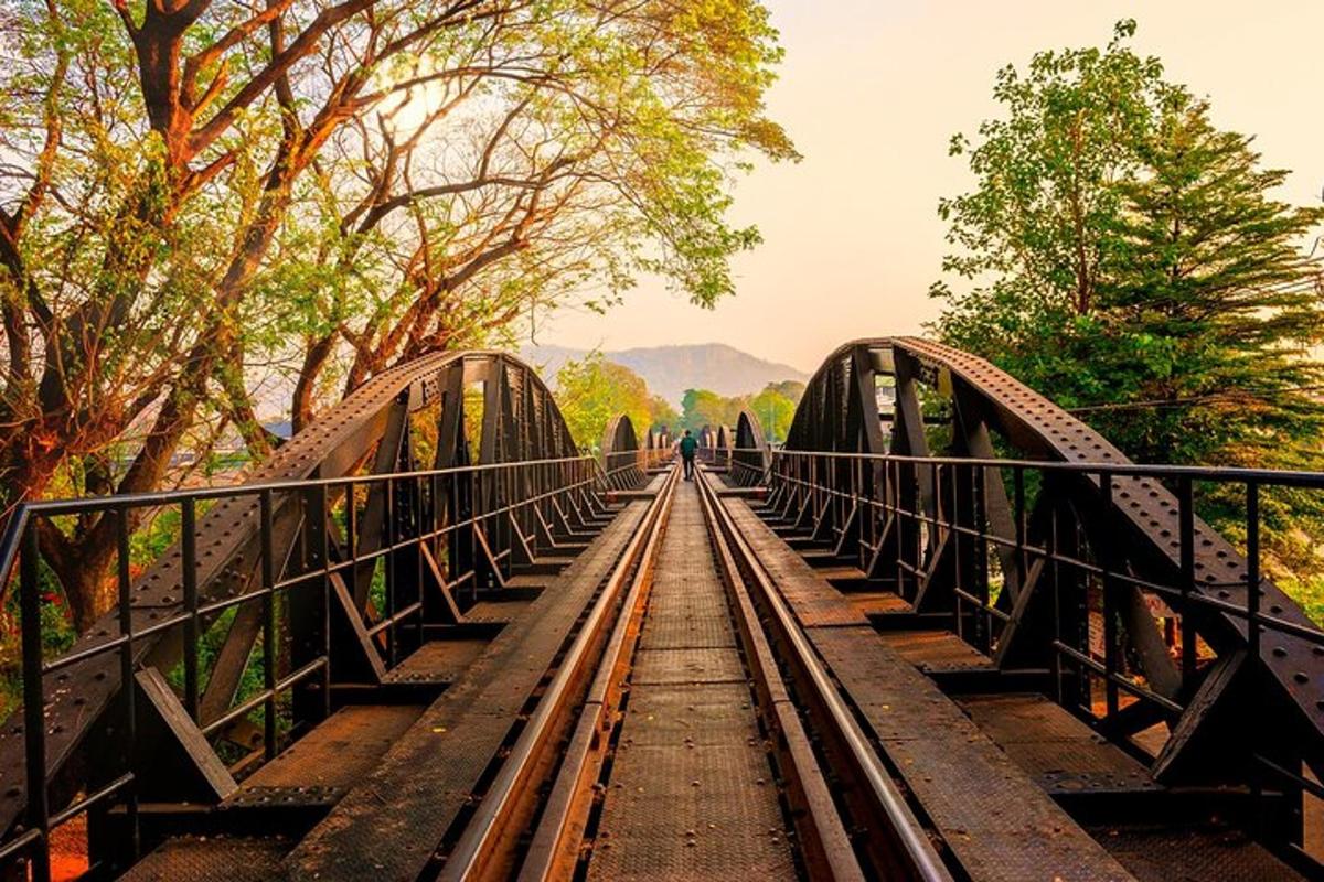 a bridge over a river with a train tracks