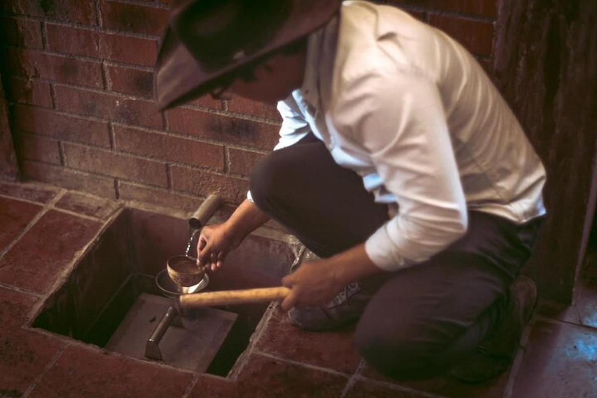 a man is using a pot with a spoon
