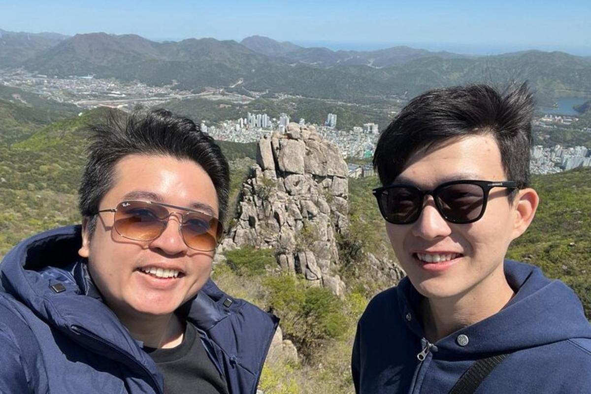 two people standing on top of a mountain