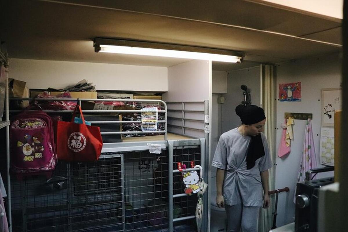 a person holding a skateboard in a room