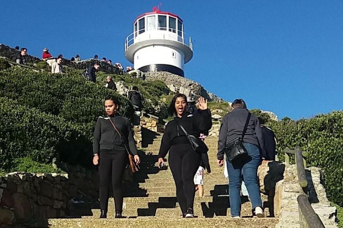 un gruppo di persone che sale le scale verso un faro