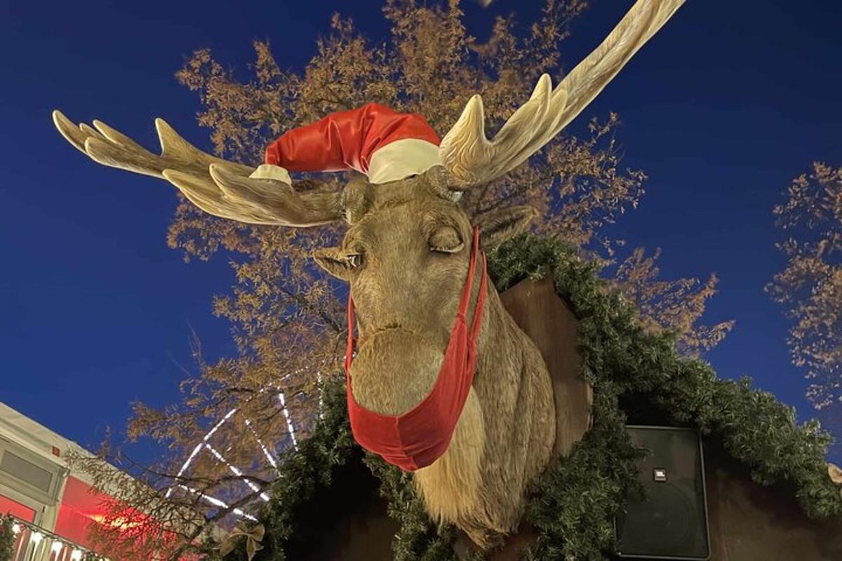 a statue of a reindeer wearing a santa hat
