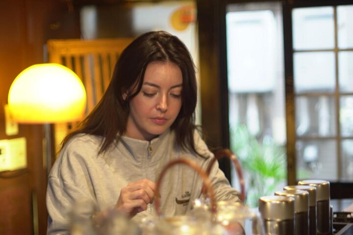 a young woman sitting at a table looking at