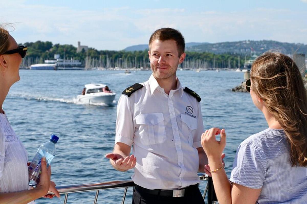 a man standing on a boat with two women