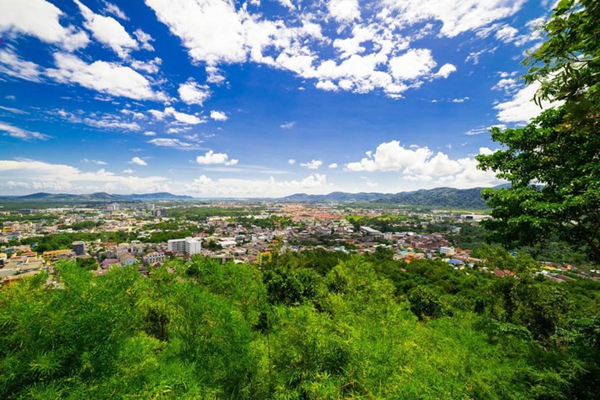 a view of a city under a blue sky with clouds