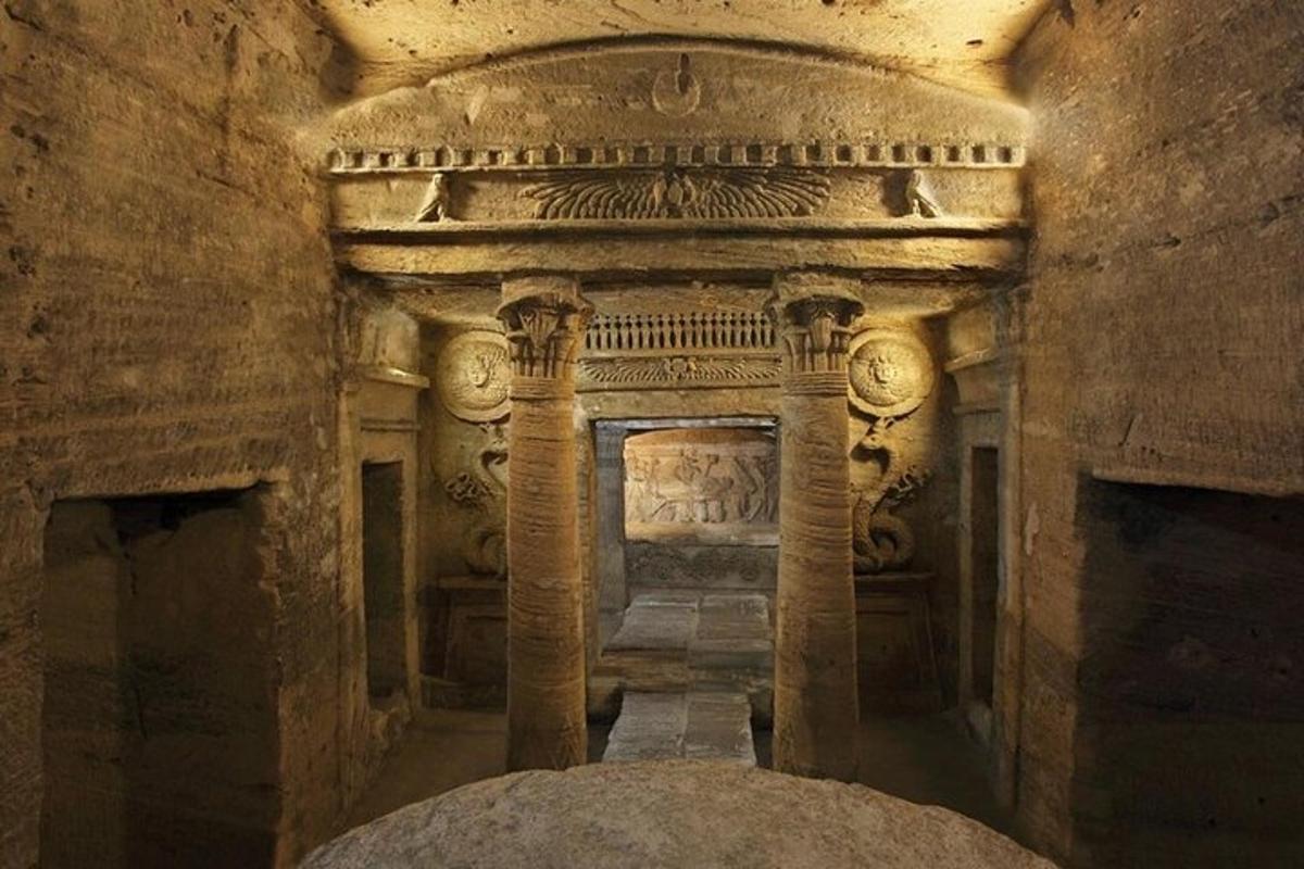 an old stone building with columns in a cave