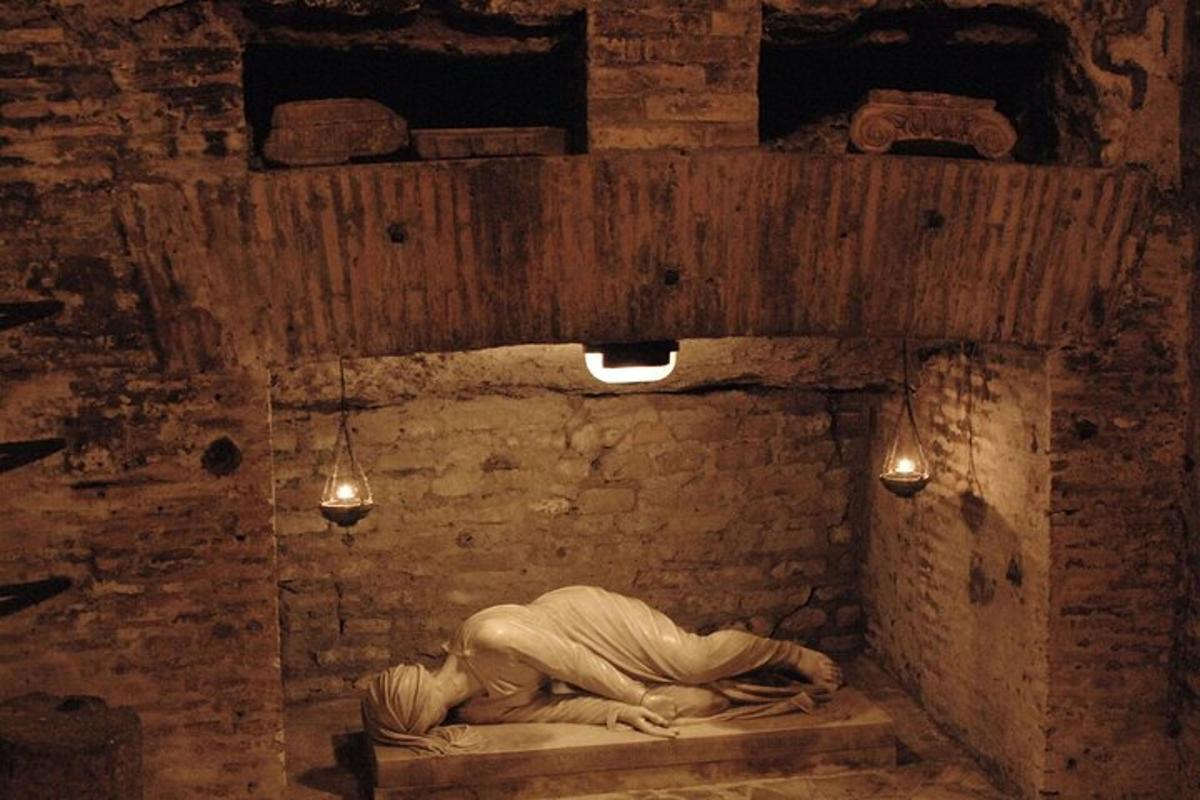 a person laying on a bed in a brick room